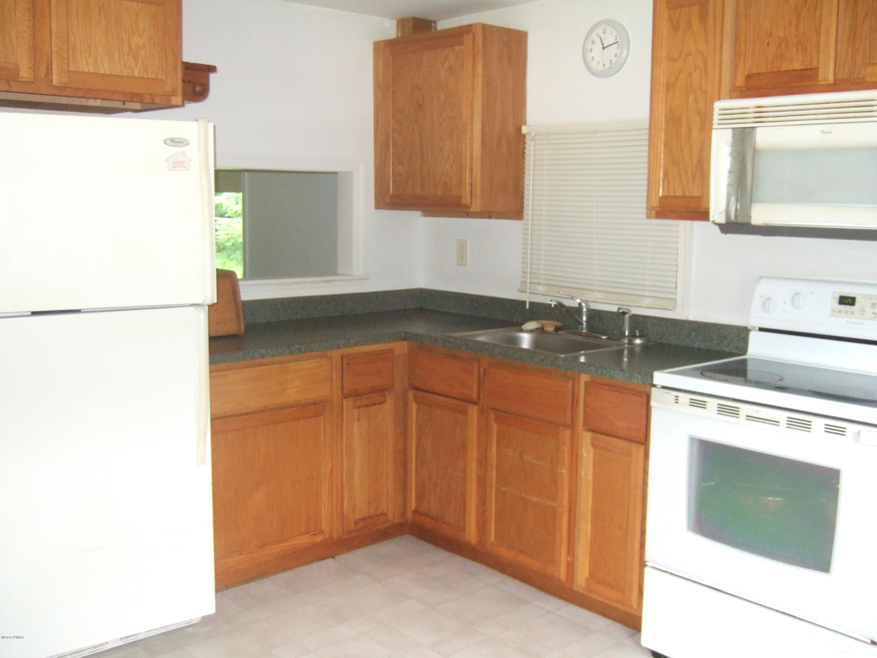 479 Roemerville Road Greentown, PA 18426 - Photo 6 of 30 a kitchen with granite countertop a sink a stove and a refrigerator