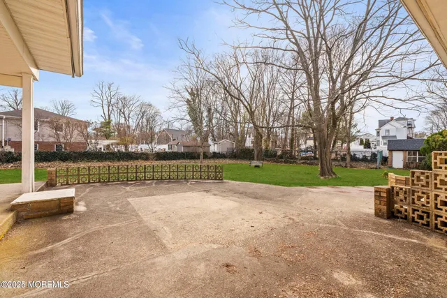 a view of a yard with a house in the background