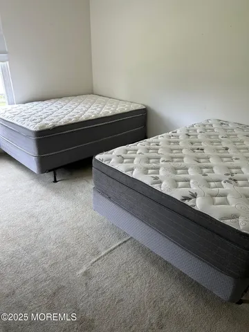 a bed sitting in a bedroom next to a wooden cabinet