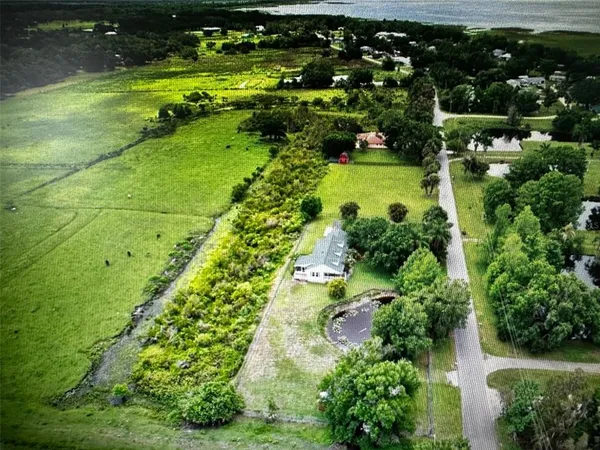 an aerial view of a yard with a lake view