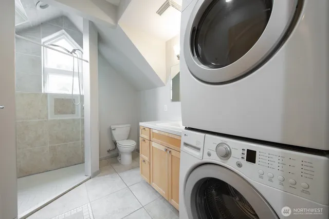 a view of a bathroom with washing machine and sink