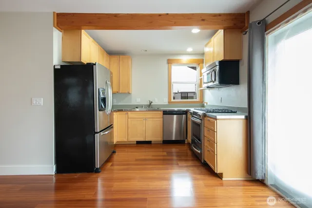 a kitchen with a refrigerator and a sink