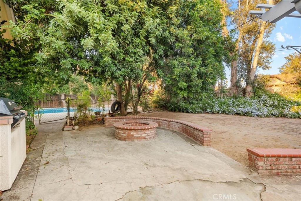 2807 Wyoming Way Riverside, CA 92506 - Photo 27 of 40 a backyard of a house with barbeque oven table and chairs