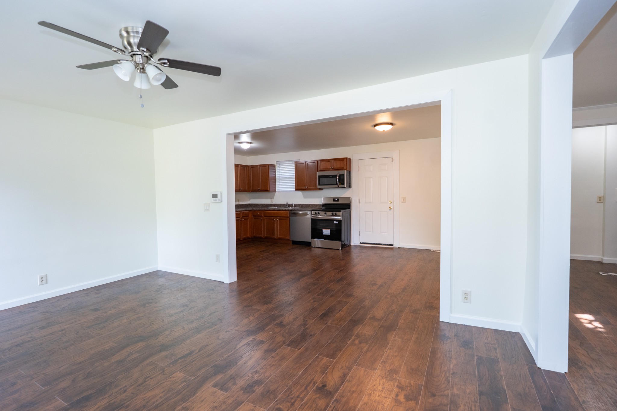 121 Tomarand Road Antioch, TN 37013 - Photo 4 of 34 wooden floor in an empty room with a window