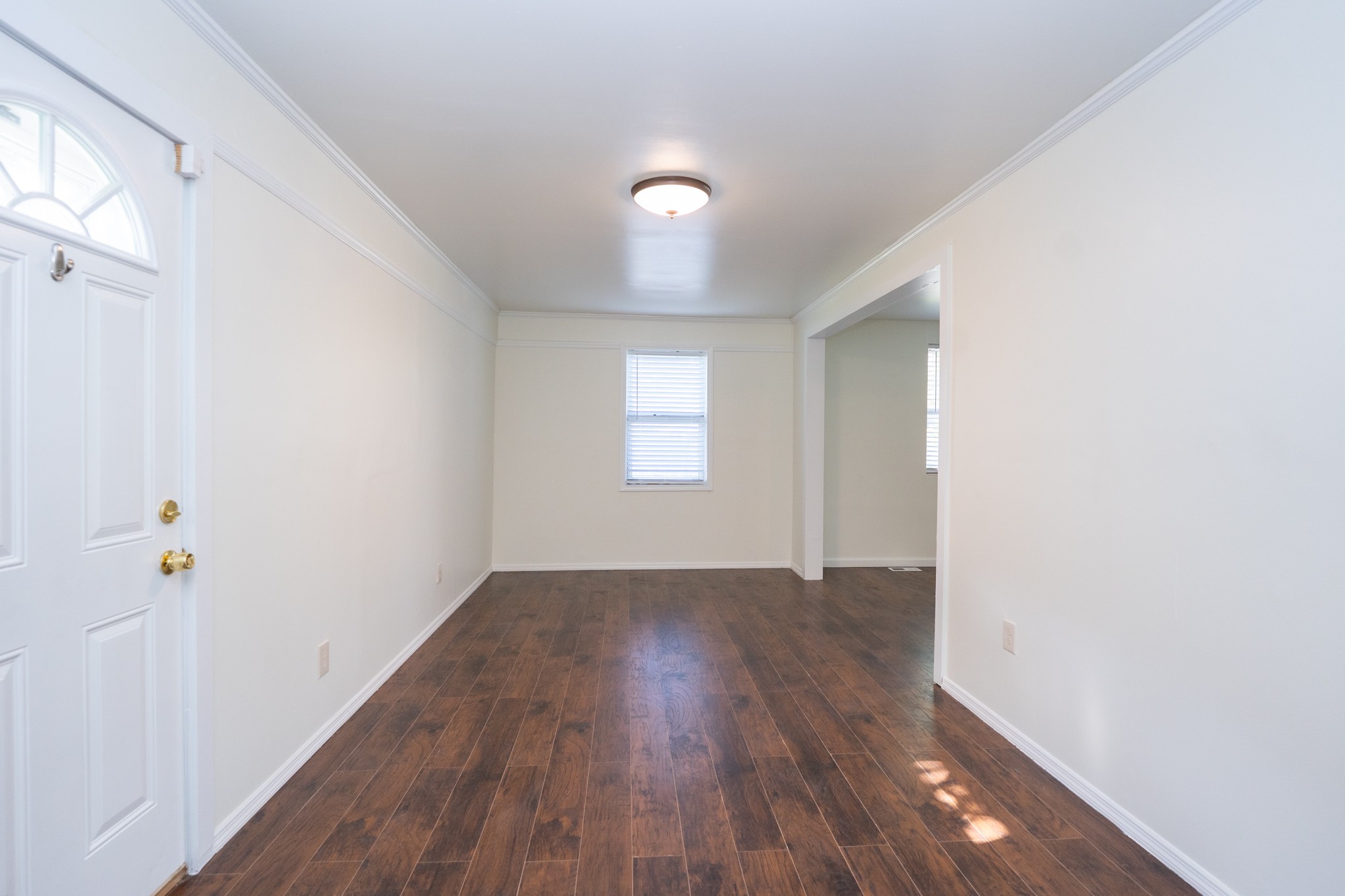 121 Tomarand Road Antioch, TN 37013 - Photo 8 of 34 an empty room with wooden floor and window