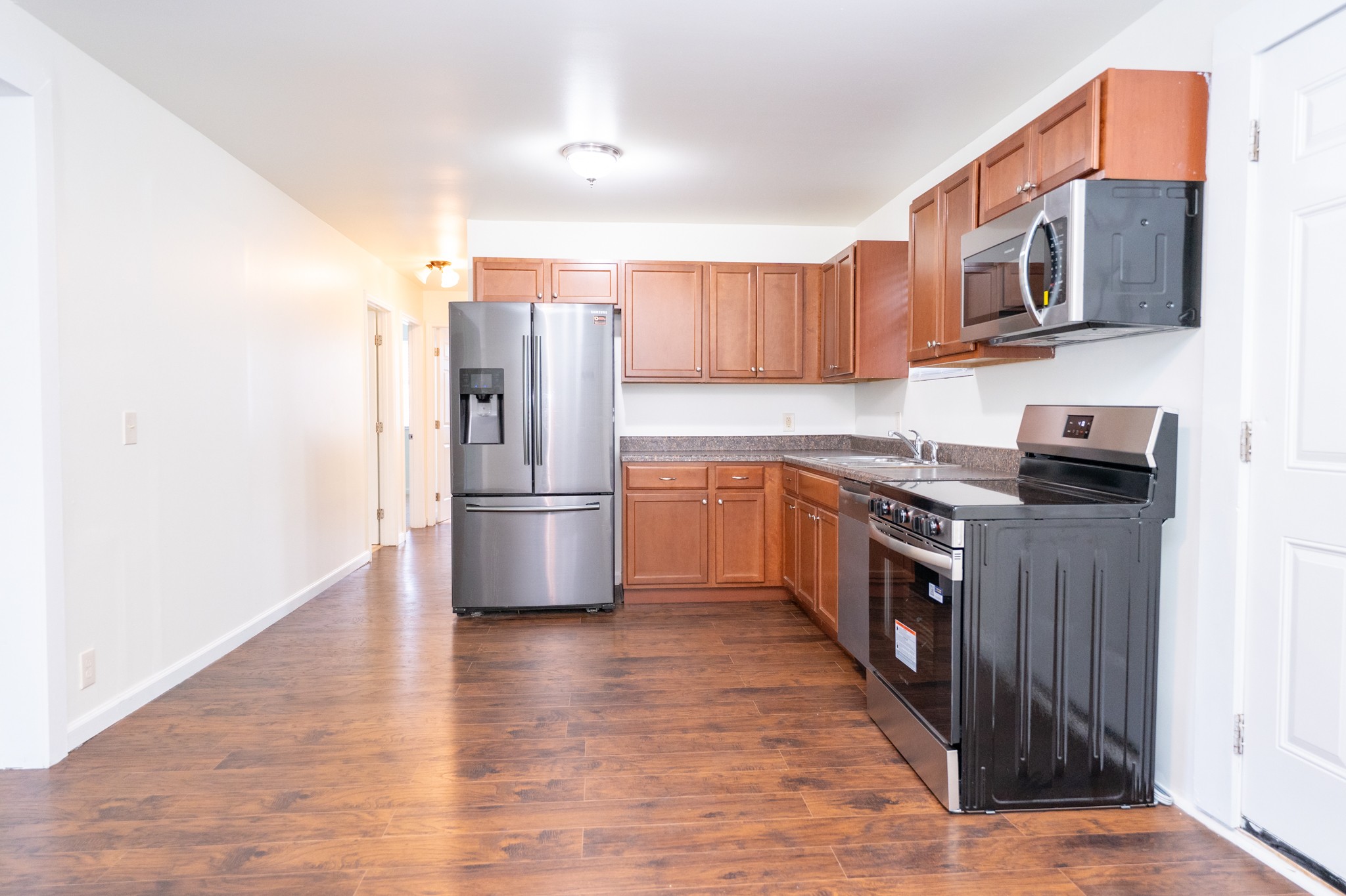121 Tomarand Road Antioch, TN 37013 - Photo 9 of 34 a kitchen with stainless steel appliances a refrigerator a stove top oven a sink dishwasher and wooden cabinets