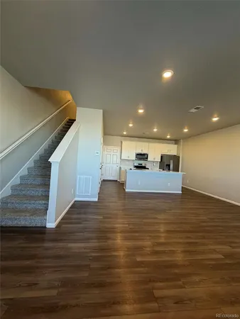 a view of kitchen and hall with wooden floor