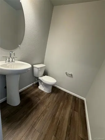 a bathroom with a sink toilet and a mirror