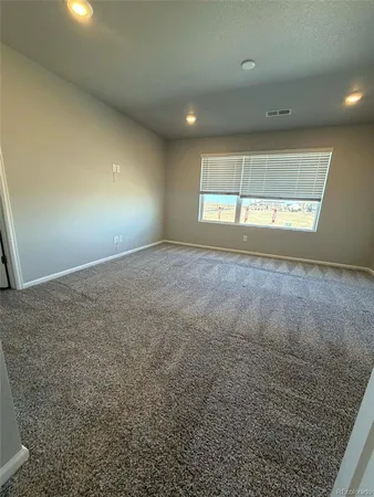 an empty room with a empty space and windows