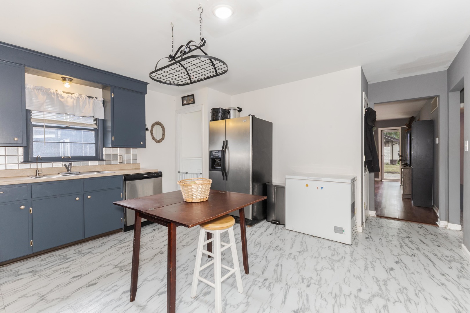 413 East Timber Street Pontiac, IL 61764 - Photo 12 of 36 a kitchen with stainless steel appliances kitchen island granite countertop a table chairs in it and wooden floors