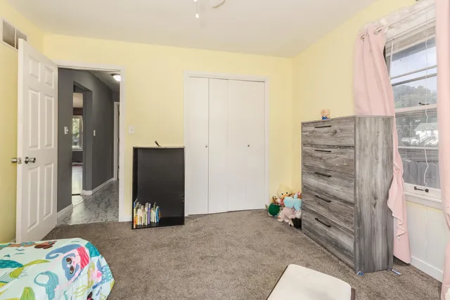 a view of a bedroom with closet and cabinet