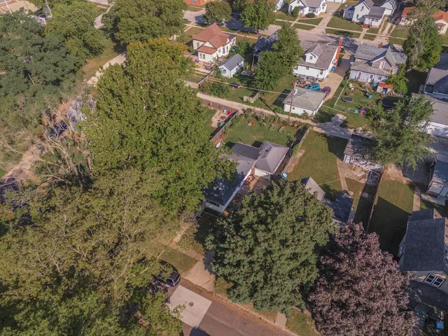an aerial view of a house with a yard
