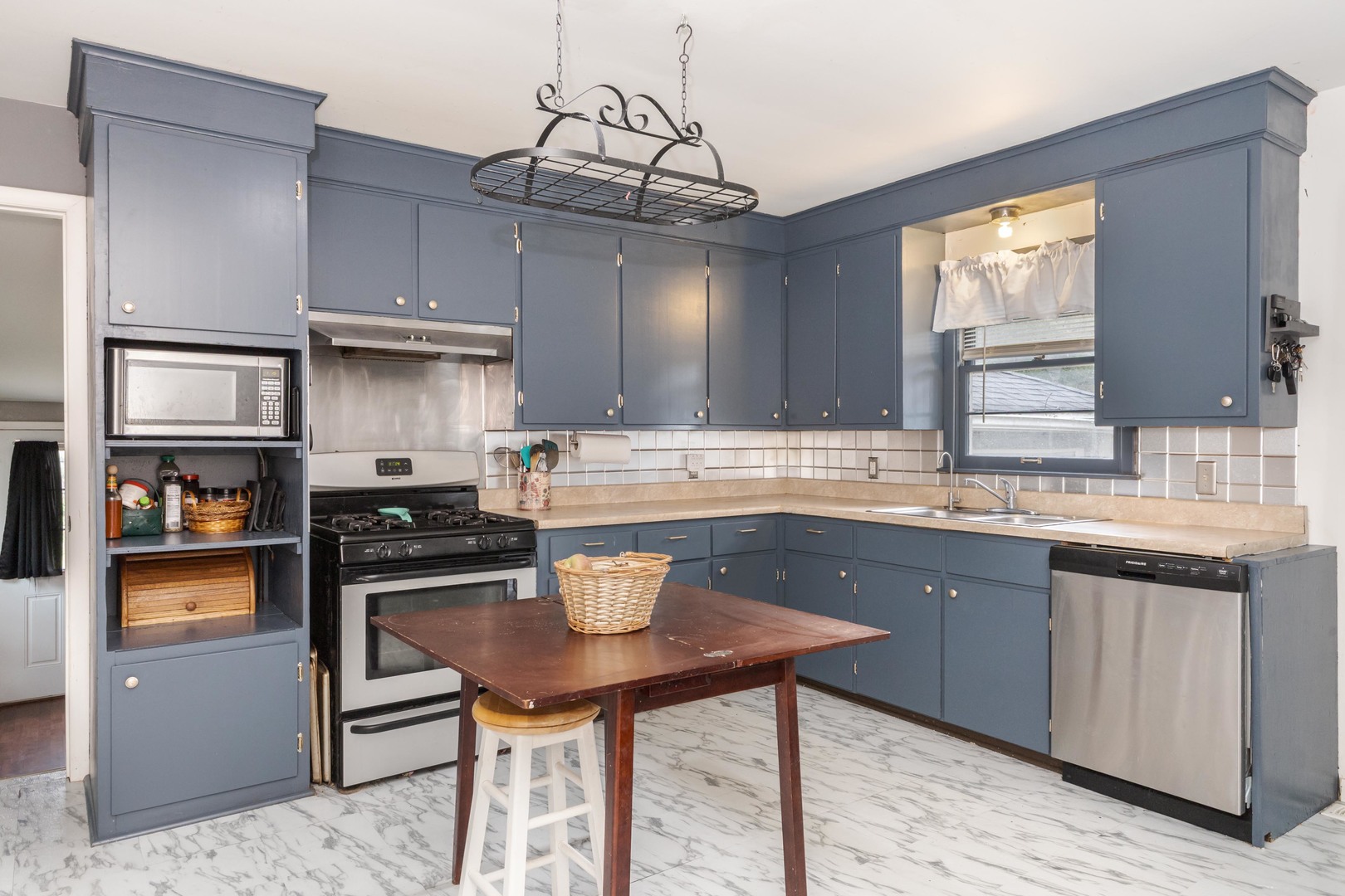 413 East Timber Street Pontiac, IL 61764 - Photo 9 of 36 a kitchen with stainless steel appliances granite countertop a sink a stove a refrigerator cabinets and dining table