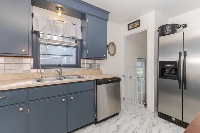 a kitchen with a sink and refrigerator