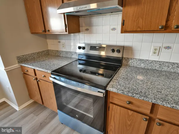 a kitchen with granite countertop a sink and cabinets