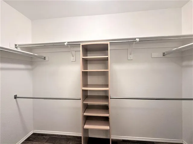 a bathroom with a tub sink double vanity and a mirror