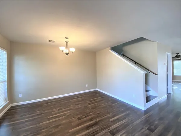 a view of a room with wooden floor and staircase