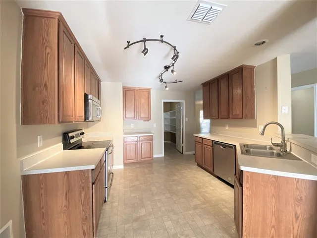 a view of a living room with hardwood floor and a ceiling fan