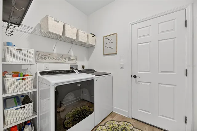 a view of living room kitchen with a flat screen tv and furniture