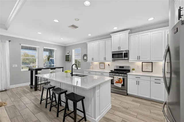 a large kitchen with a table and chairs