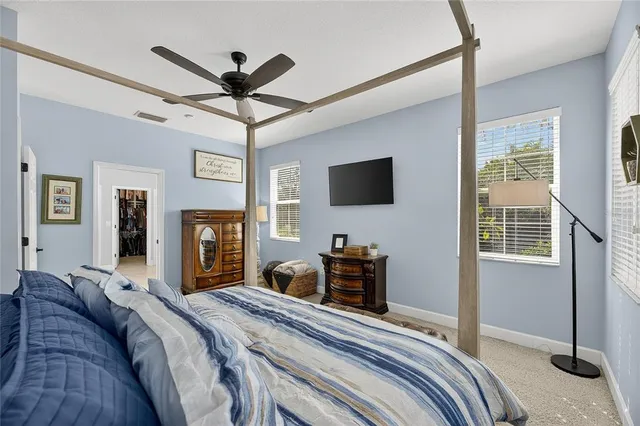 a view of walk in closet with clothes