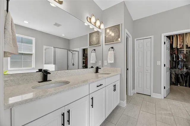 a living room with stainless steel appliances furniture and a flat screen tv
