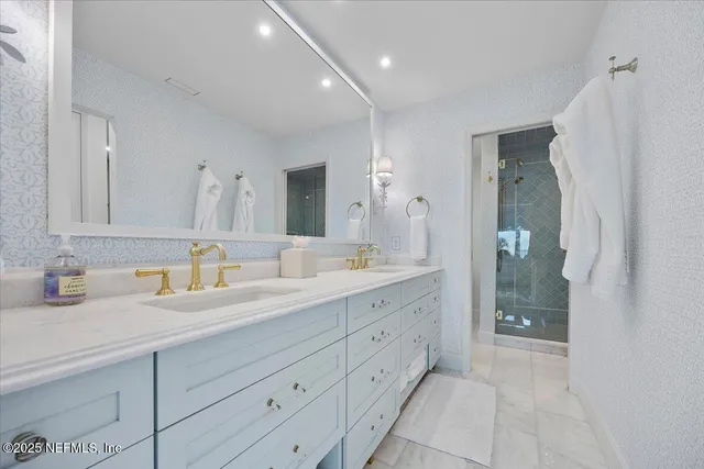 a bathroom with a granite countertop sink mirror and double