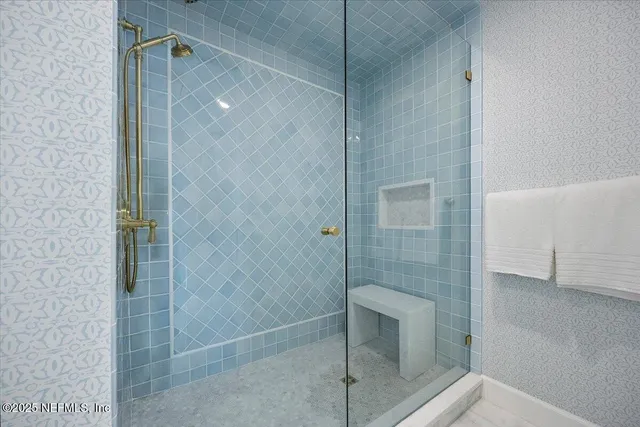 a bathroom with a shower and a sink