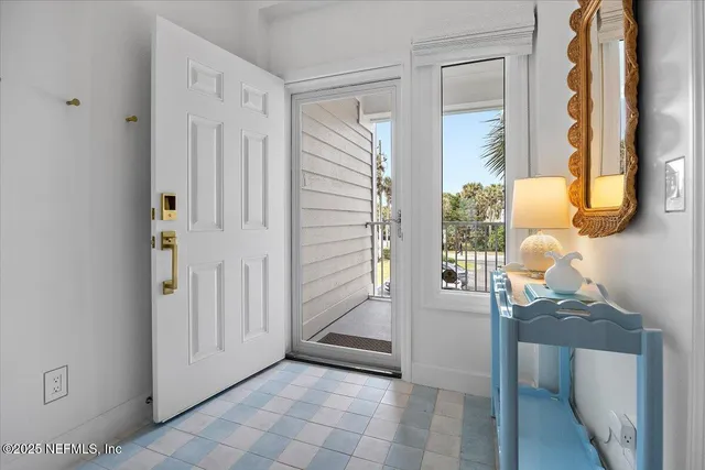 a view of a room that has a bed and a dresser in it