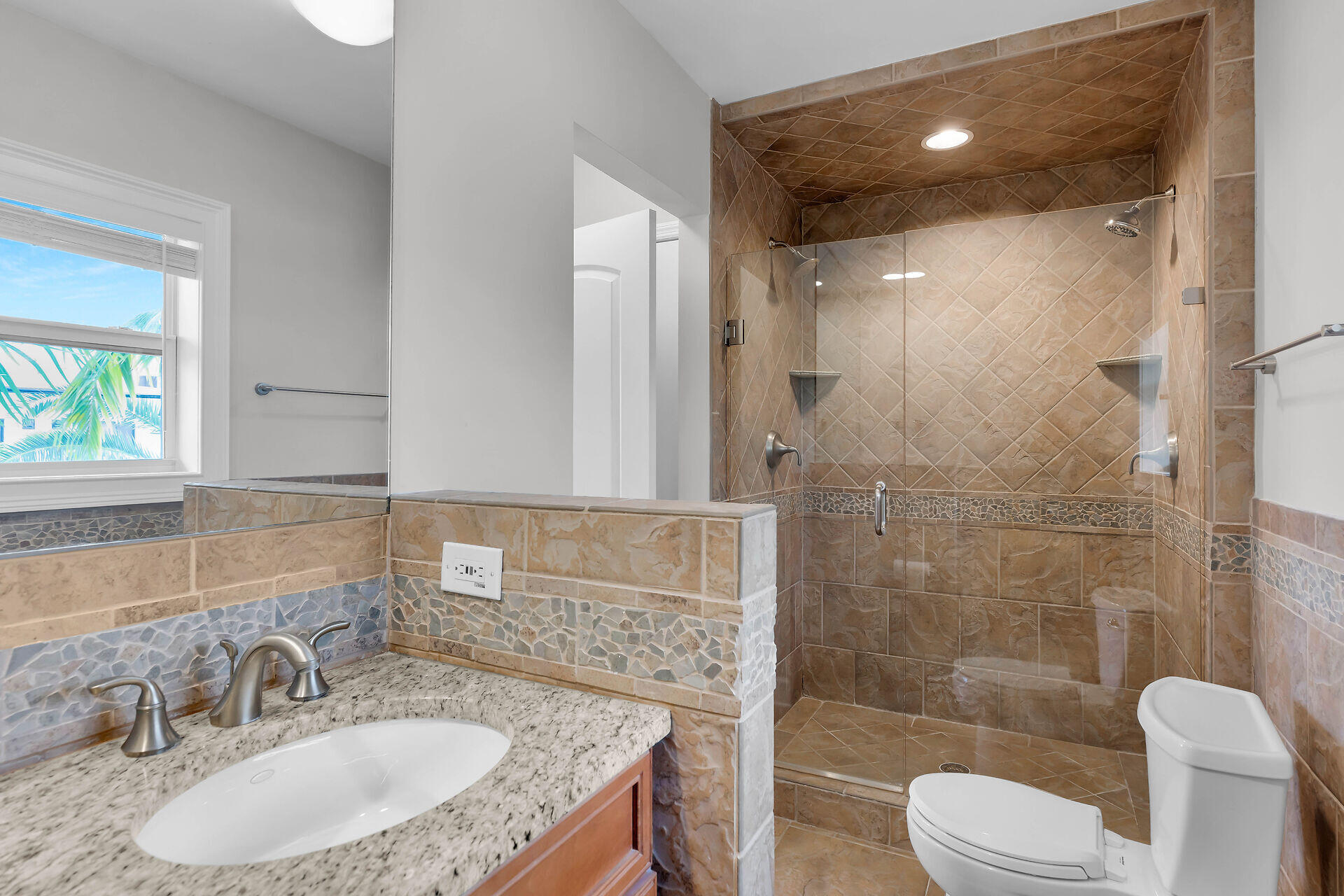 272 West Seaview Drive Duck Key, FL 33050 - Photo 14 of 26 a bathroom with a granite countertop sink toilet a mirror and shower