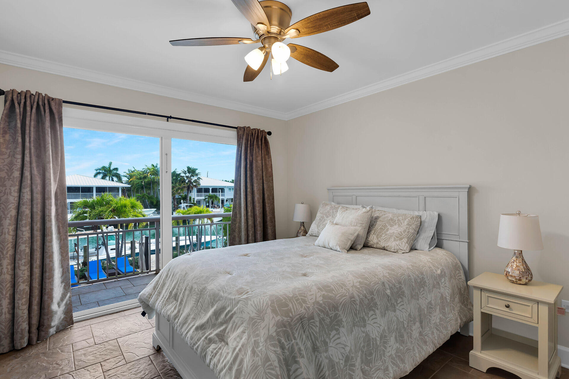 272 West Seaview Drive Duck Key, FL 33050 - Photo 15 of 26 a large bed sitting in a bedroom next to a window