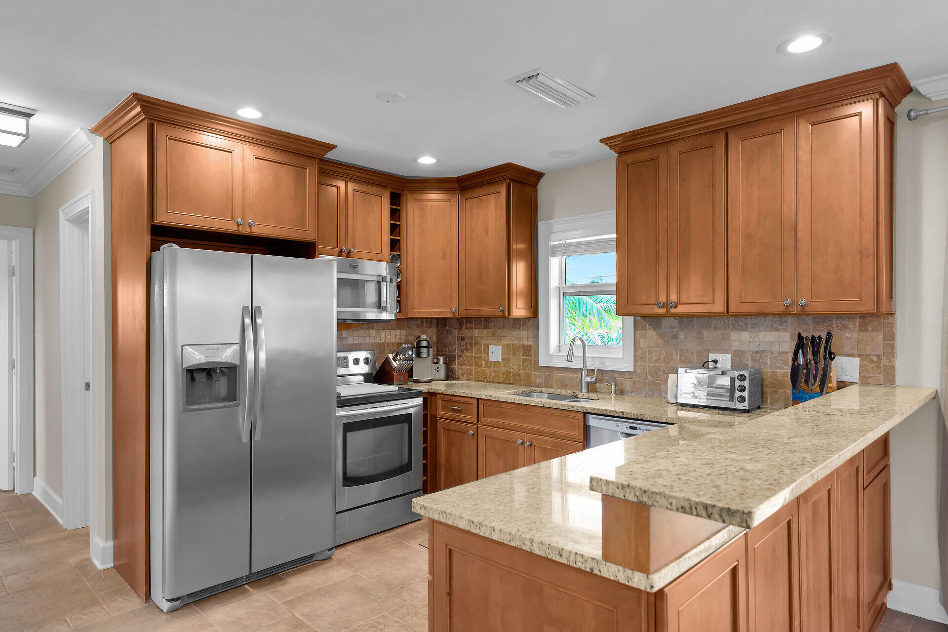 272 West Seaview Drive Duck Key, FL 33050 - Photo 8 of 26 a kitchen with stainless steel appliances granite countertop a refrigerator sink and cabinets