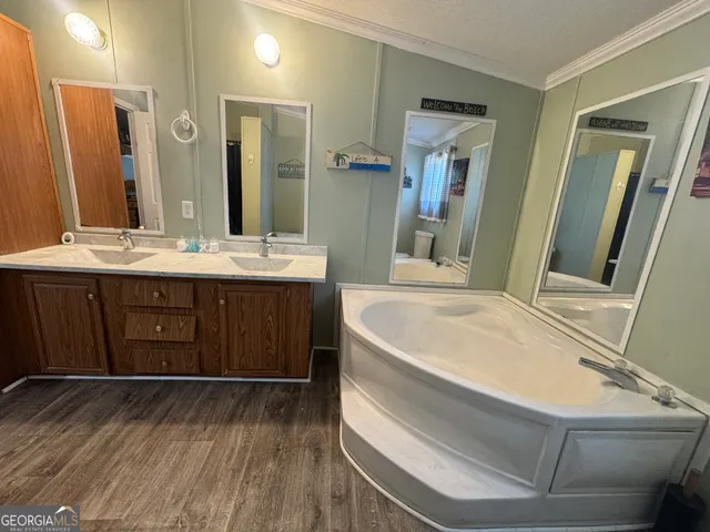 a spacious bathroom with a granite countertop sink and a mirror