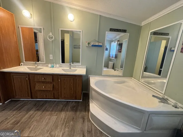 a bathroom with a bathtub sink and mirror