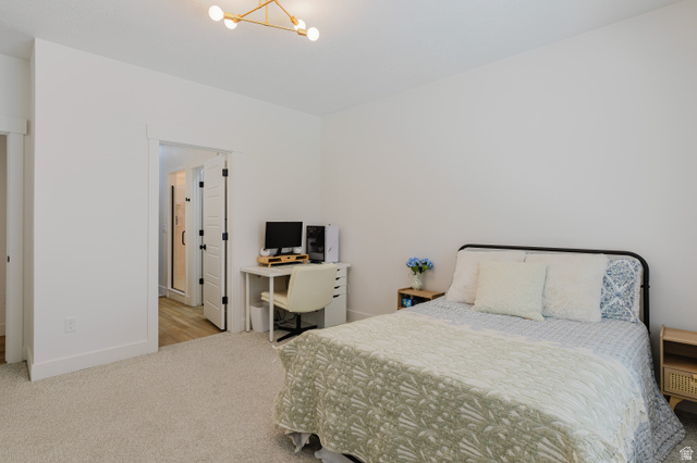 287 East 1000 North Logan, UT 84321 - Photo 21 of 41 Spacious room featuring neutral carpeting, white walls, and a contemporary ceiling light fixture