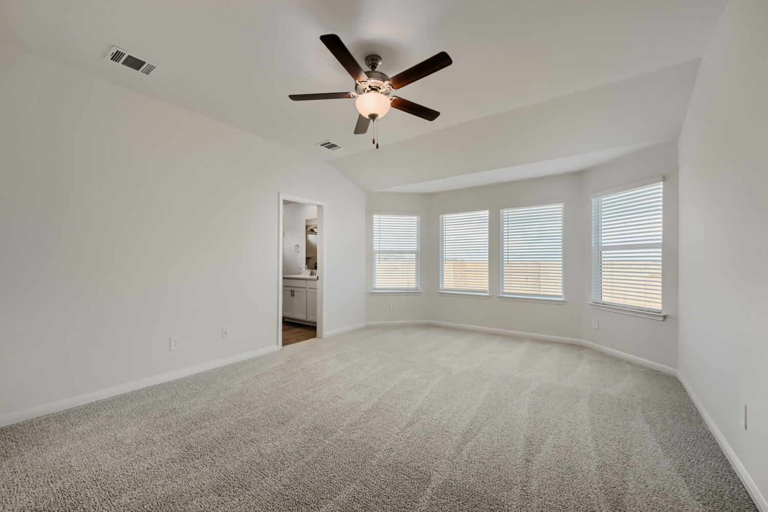 146 Diablo Rim Terrace Dripping Springs, TX 78620 - Photo 18 of 32 A spacious bedroom featuring soft carpeting and a ceiling fan, offering a bright and comfortable retreat.