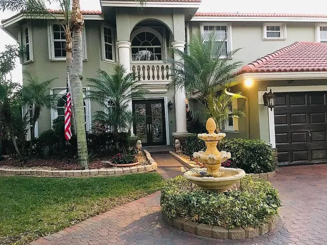 a front view of a house with garden