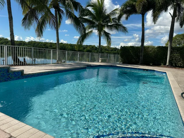 a view of swimming pool with a garden and lake view