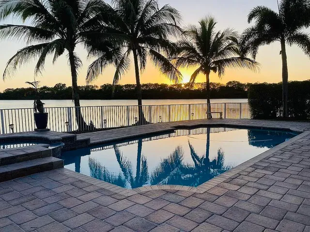 a view of outdoor space with swimming pool and wooden fence