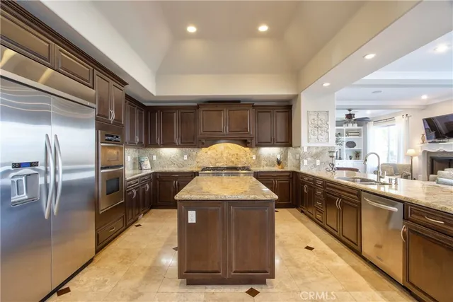 a kitchen with stainless steel appliances granite countertop a sink stove and cabinets
