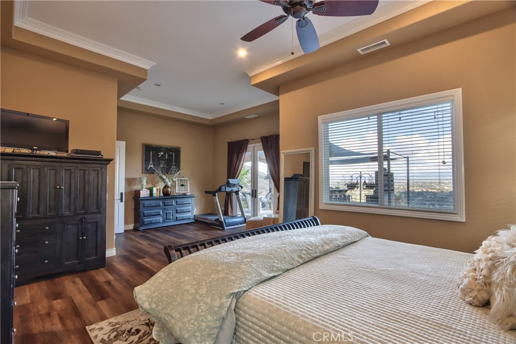 44195 Vía Horca Temecula, CA 92590 - Photo 25 of 74 a bedroom with a bed and wooden floor