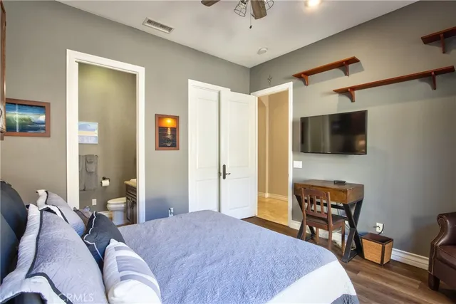 a living room with furniture ceiling fan and a large window