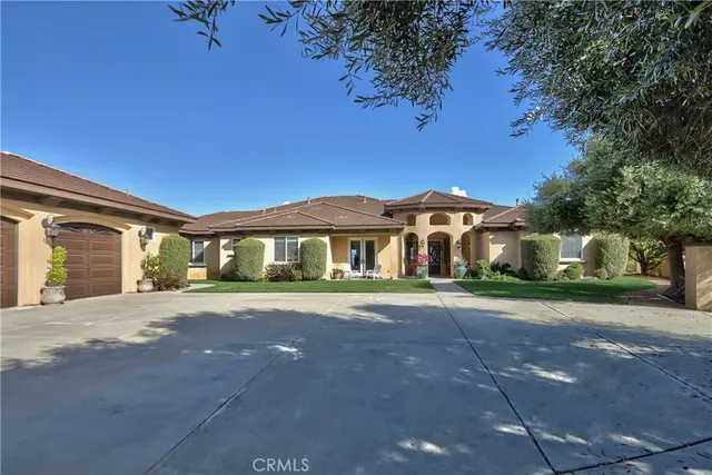 a front view of a house with a yard and a garage