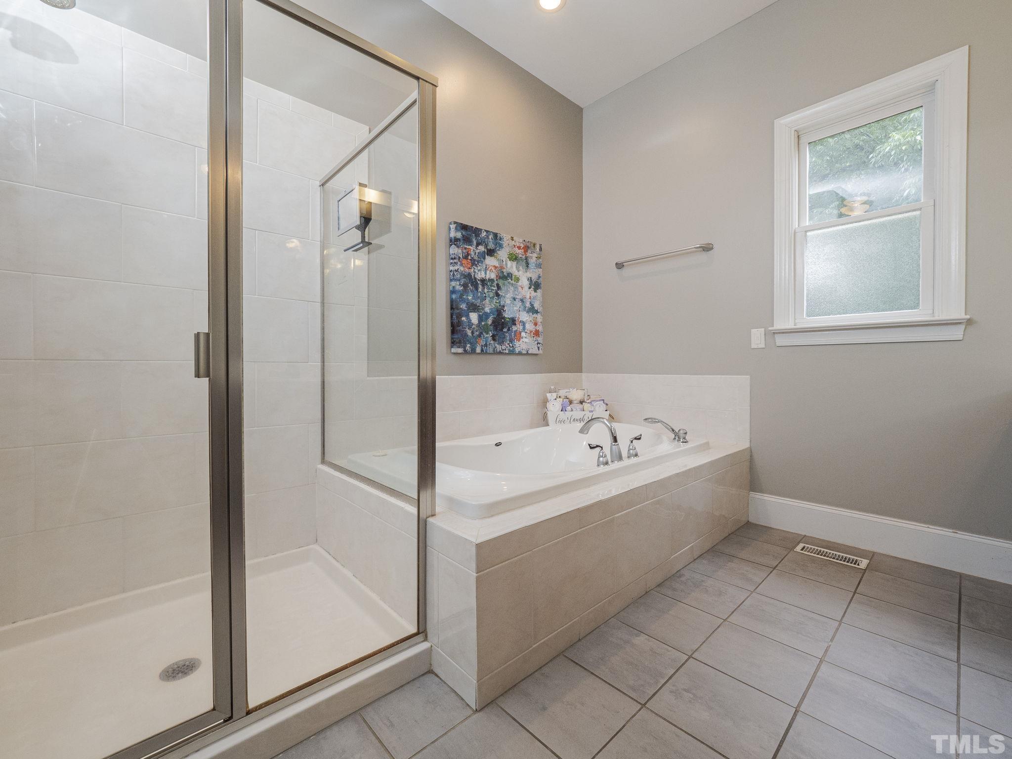 404 Brooks Avenue Raleigh, NC 27607 - Photo 13 of 18 a bathroom with a bathtub and a shower