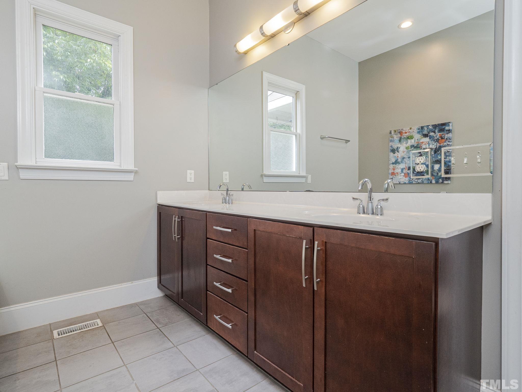 404 Brooks Avenue Raleigh, NC 27607 - Photo 14 of 18 a bathroom with a sink vanity and mirror