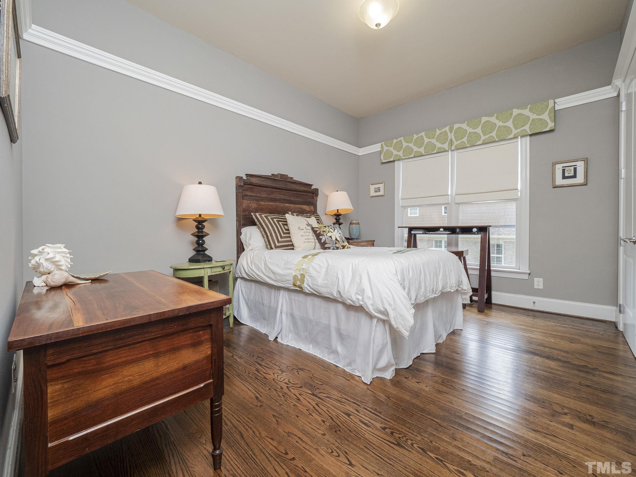 404 Brooks Avenue Raleigh, NC 27607 - Photo 16 of 18 a bedroom with a bed and wooden floor