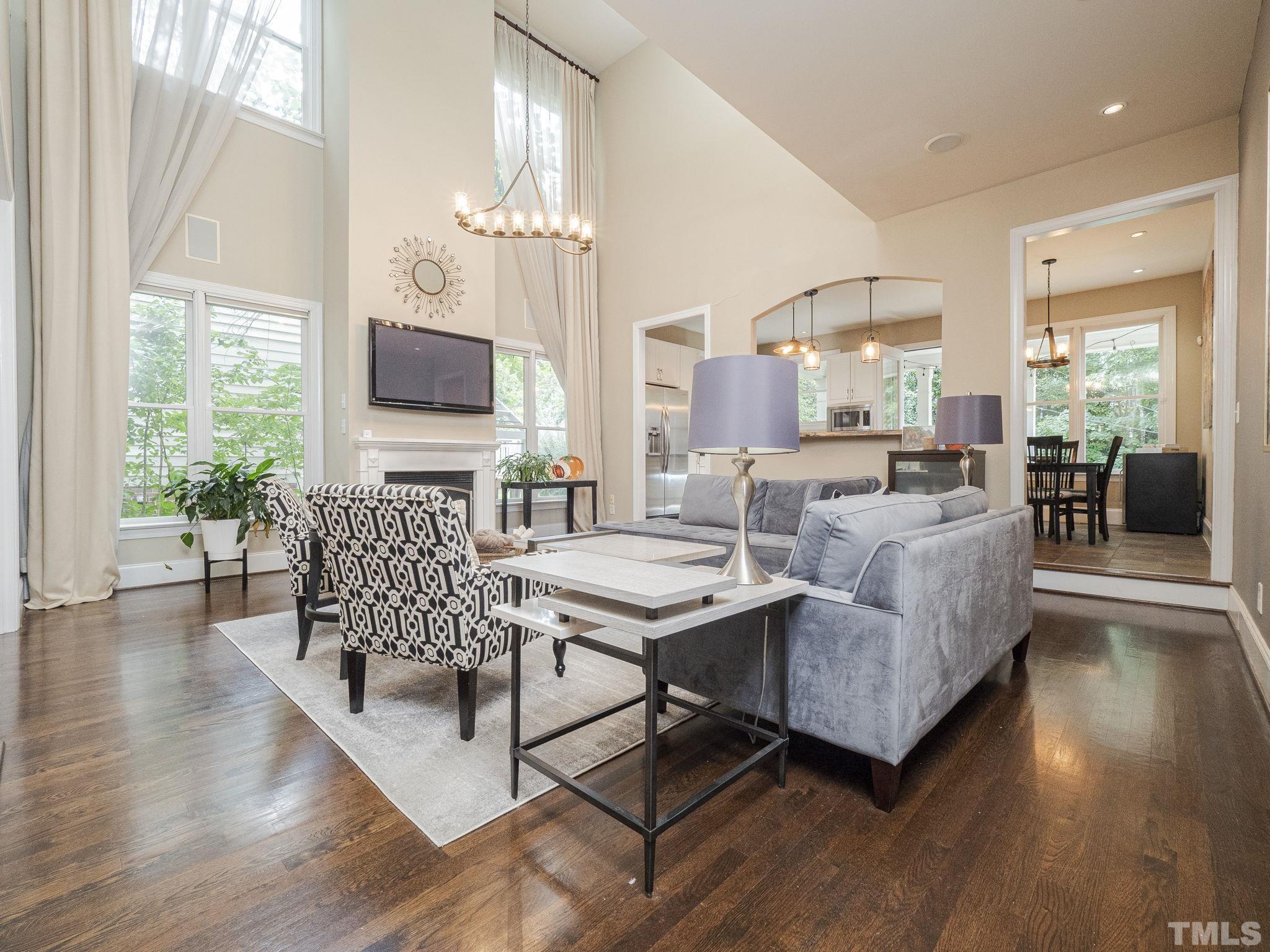 404 Brooks Avenue Raleigh, NC 27607 - Photo 3 of 18 a living room with furniture floor to ceiling window and wooden floor