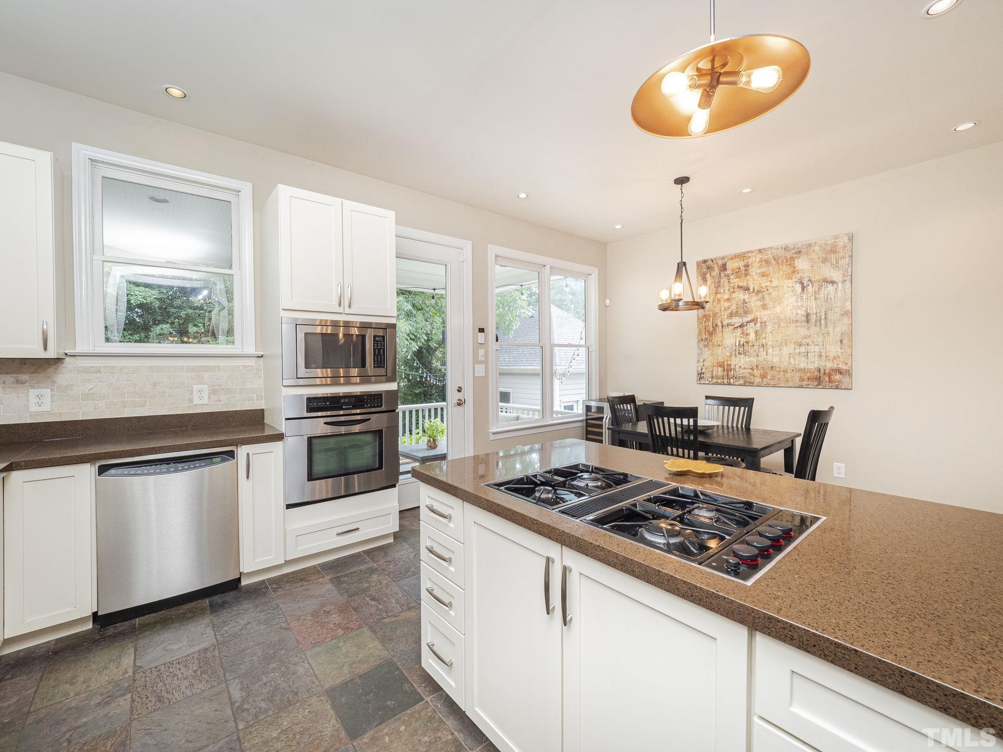404 Brooks Avenue Raleigh, NC 27607 - Photo 6 of 18 a kitchen with a stove a sink and a window