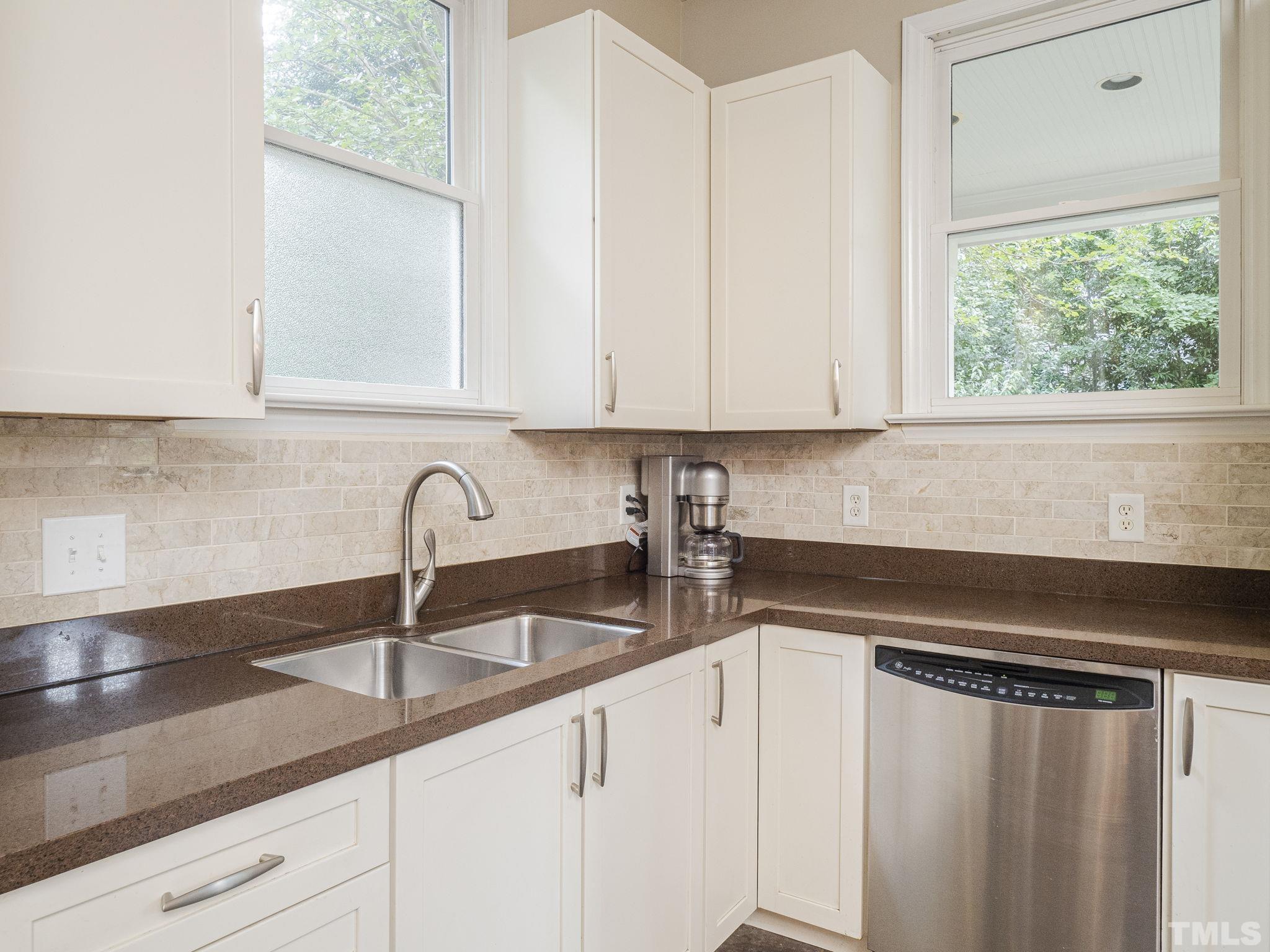 404 Brooks Avenue Raleigh, NC 27607 - Photo 7 of 18 a kitchen with granite countertop white cabinets and a sink
