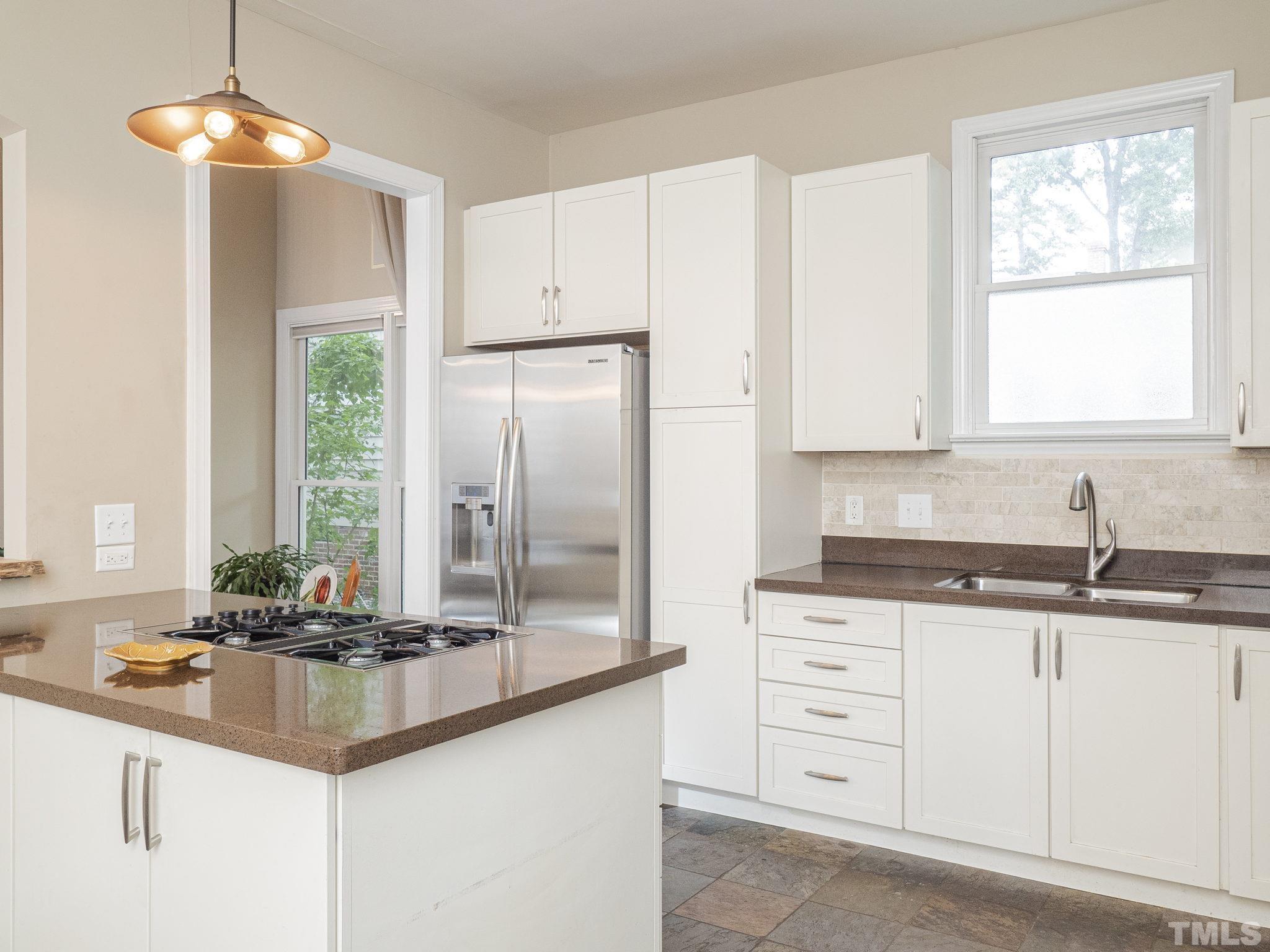 404 Brooks Avenue Raleigh, NC 27607 - Photo 10 of 18 a kitchen with granite countertop a sink cabinets and window